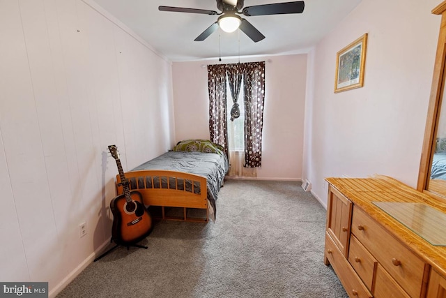 carpeted bedroom with ceiling fan and crown molding