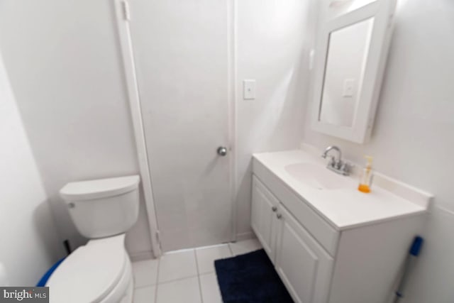 bathroom with tile patterned flooring, vanity, and toilet