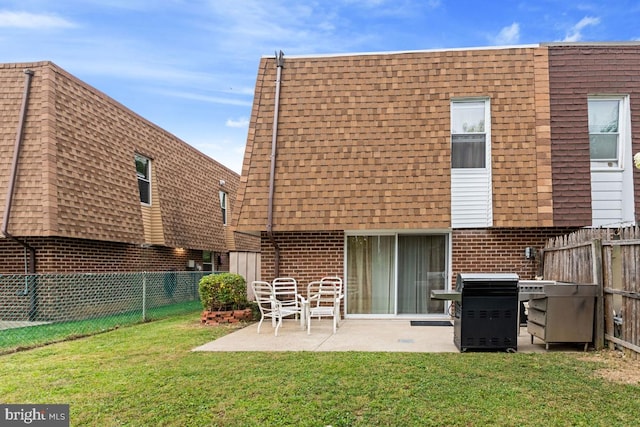 back of house with a yard and a patio area