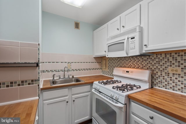 kitchen with white cabinetry, sink, butcher block countertops, white appliances, and decorative backsplash