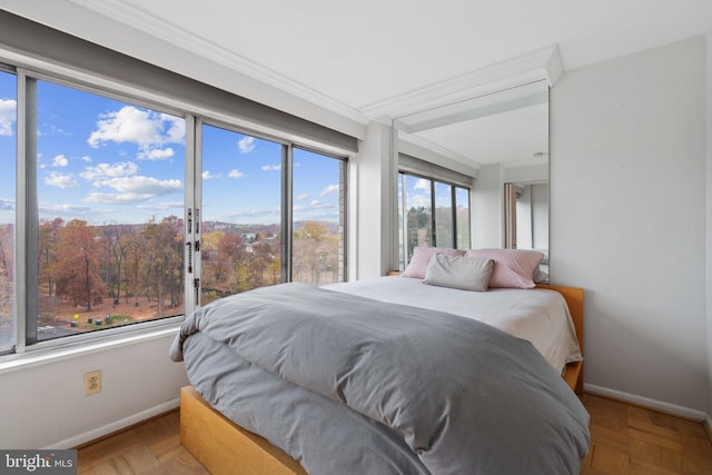 bedroom featuring light parquet flooring, multiple windows, and crown molding