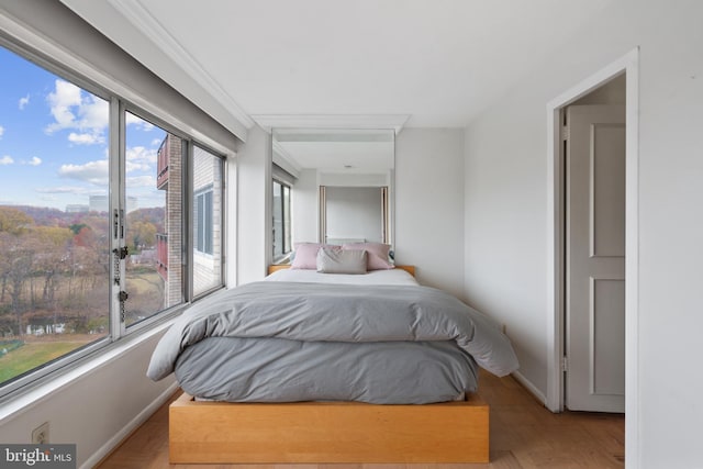 bedroom featuring light wood-type flooring and multiple windows