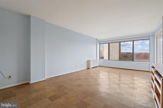 spare room featuring radiator heating unit