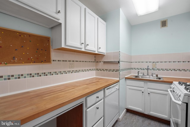 kitchen featuring sink, white cabinets, white appliances, and wood counters