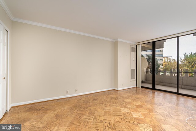 empty room featuring light parquet floors and crown molding