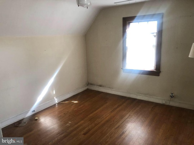 bonus room with dark hardwood / wood-style floors and lofted ceiling