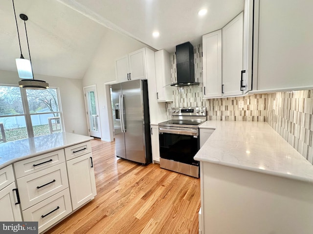 kitchen with white cabinets, wall chimney exhaust hood, stainless steel appliances, and vaulted ceiling