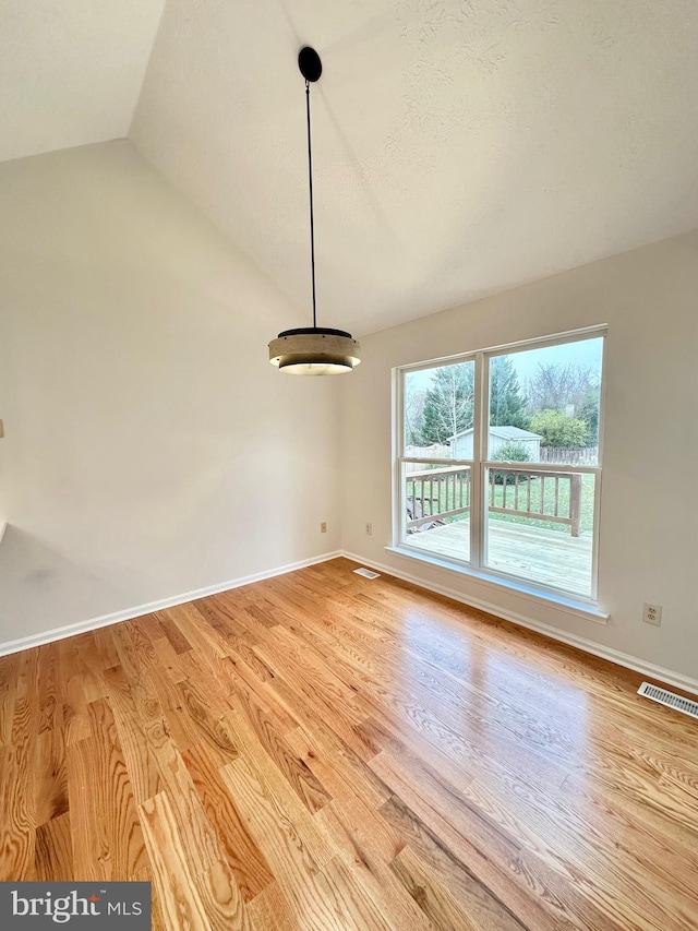 interior space featuring light hardwood / wood-style floors and vaulted ceiling