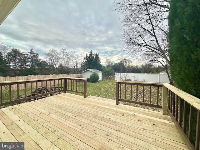 wooden terrace featuring a storage shed