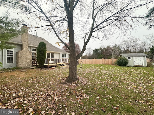 view of yard featuring a shed and a deck