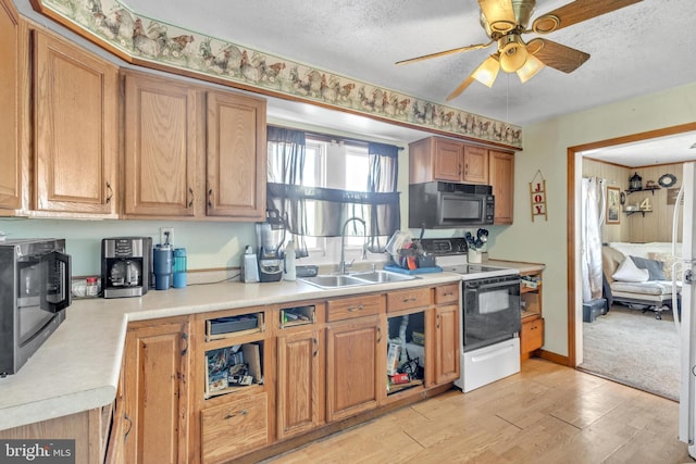 kitchen featuring a textured ceiling, white electric range, sink, and light hardwood / wood-style flooring