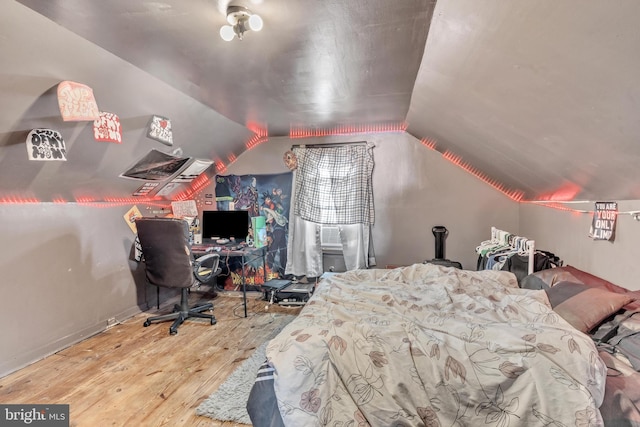 bedroom featuring hardwood / wood-style flooring and vaulted ceiling