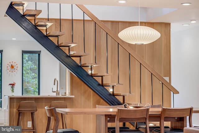 bar featuring pendant lighting and sink