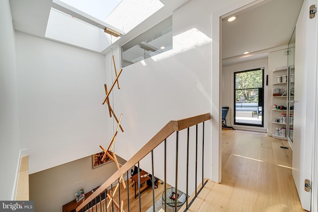 staircase featuring hardwood / wood-style flooring and a skylight