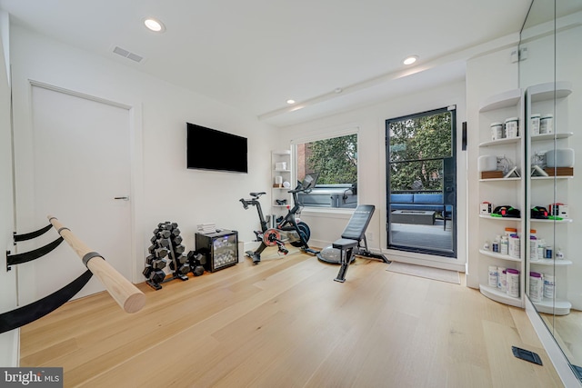 workout room with hardwood / wood-style floors