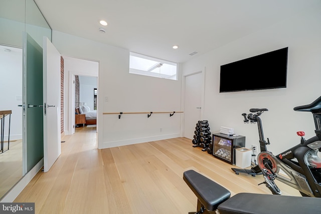 workout room with light wood-type flooring