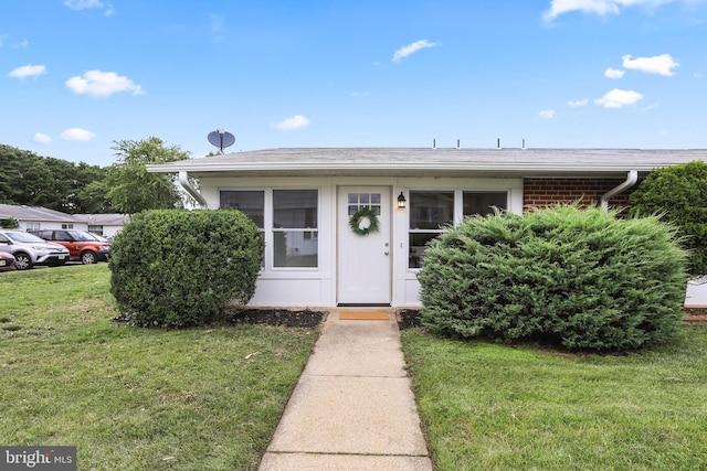 property entrance with a yard