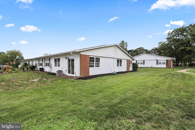 view of side of home featuring a yard and cooling unit