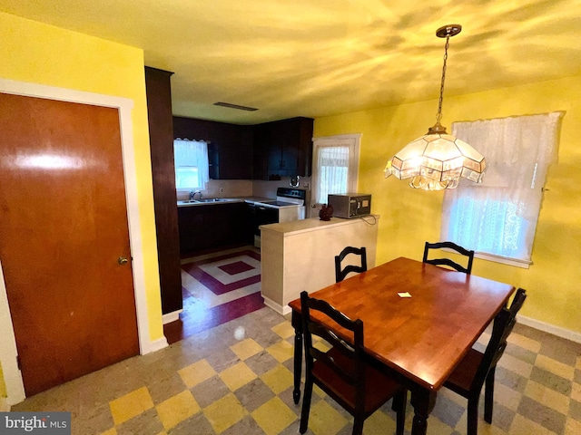 dining area featuring sink and a wealth of natural light