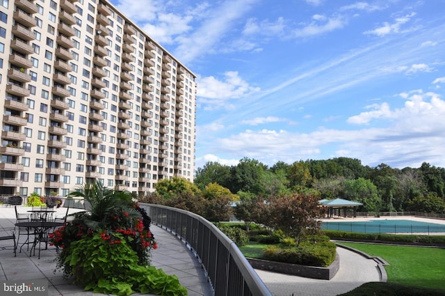 view of home's community featuring a yard and a patio area