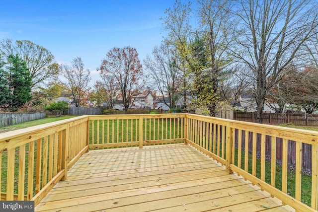 wooden terrace featuring a yard