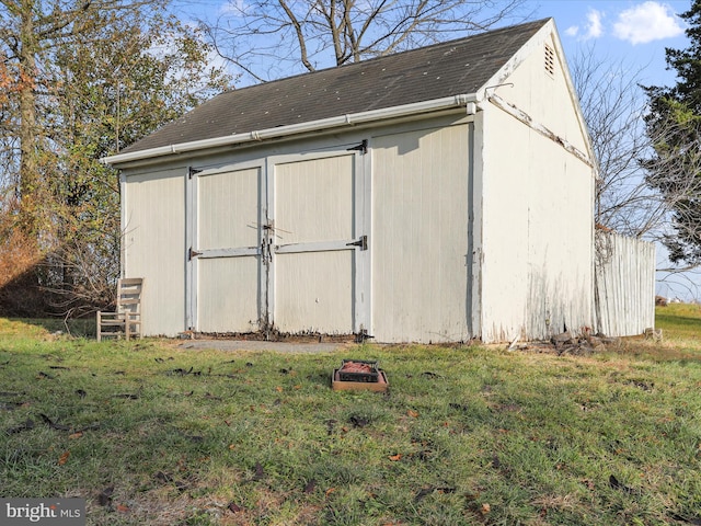 view of outbuilding featuring a lawn