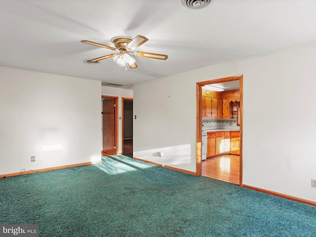 unfurnished room with ceiling fan and carpet floors