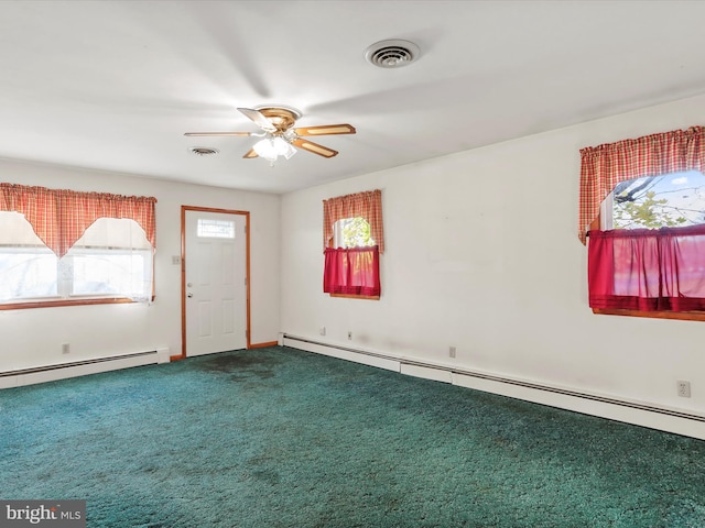 spare room featuring baseboard heating, ceiling fan, and carpet