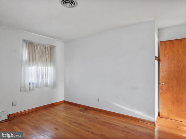 unfurnished room with wood-type flooring