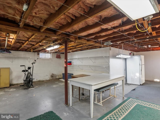 basement featuring white fridge