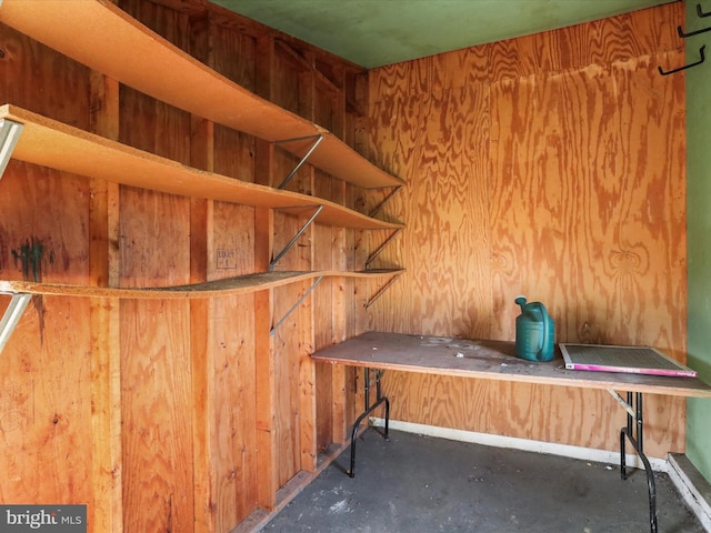 misc room featuring wooden walls