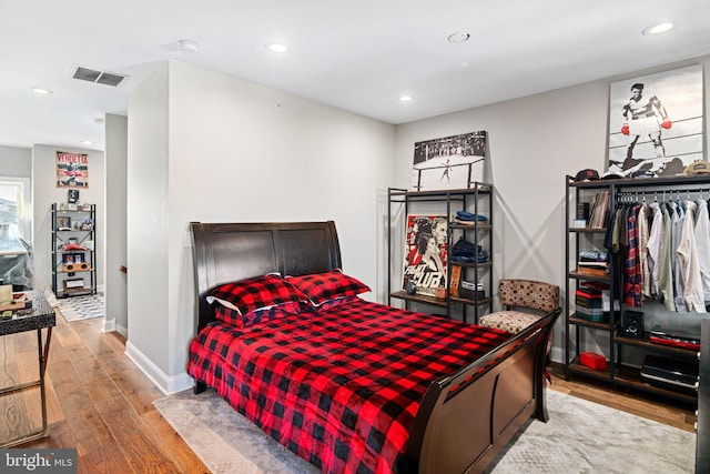 bedroom with hardwood / wood-style flooring