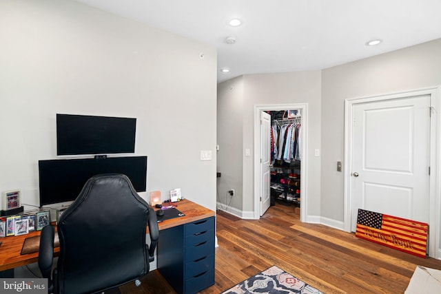 home office with dark hardwood / wood-style floors