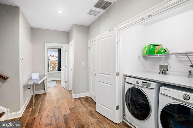 washroom with independent washer and dryer and dark hardwood / wood-style flooring