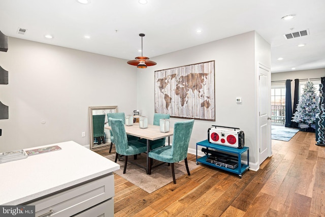 dining space with hardwood / wood-style flooring