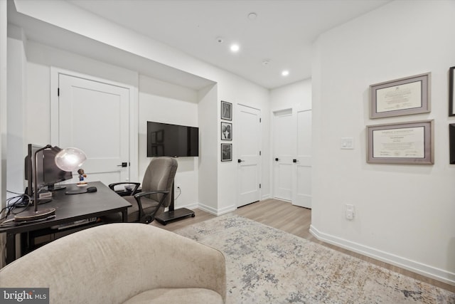 office with light hardwood / wood-style floors