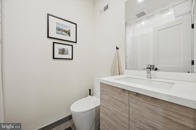 bathroom with vanity and toilet