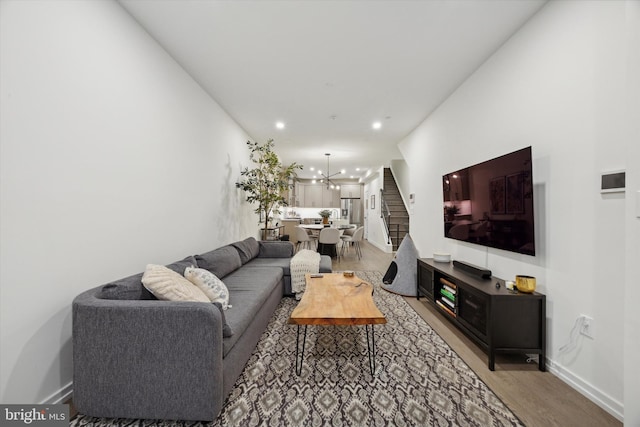 living room featuring a chandelier and light wood-type flooring