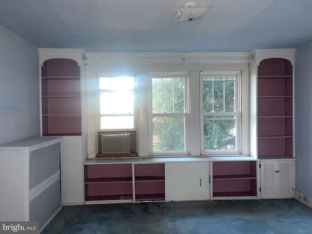 empty room with dark colored carpet, cooling unit, and heating unit