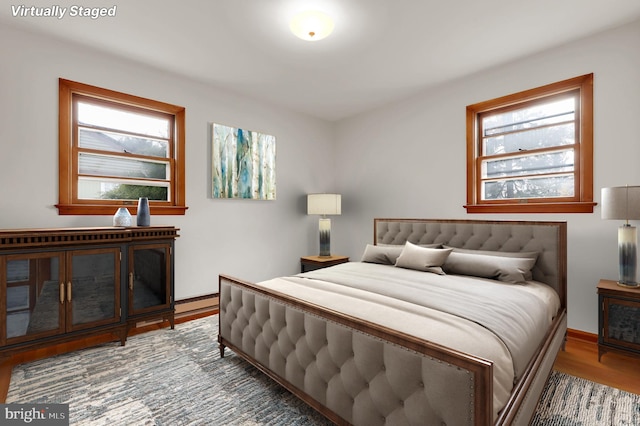 bedroom featuring multiple windows and hardwood / wood-style flooring