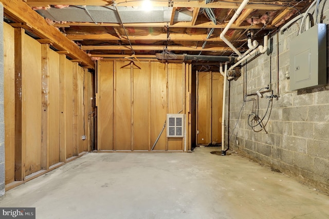 basement with electric panel and heating unit