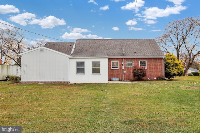 rear view of house with a yard