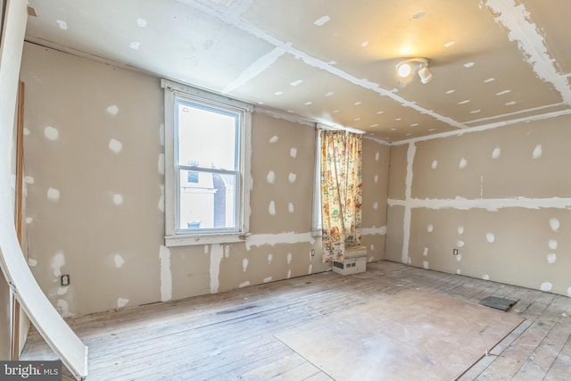 empty room with light hardwood / wood-style flooring