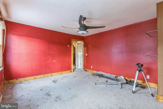 empty room featuring ceiling fan and carpet floors