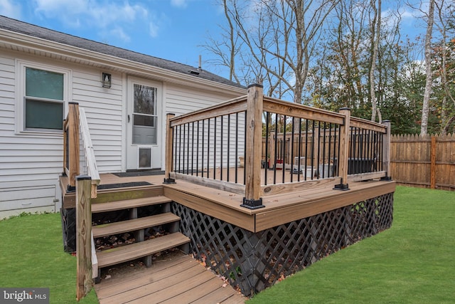 wooden terrace featuring a yard