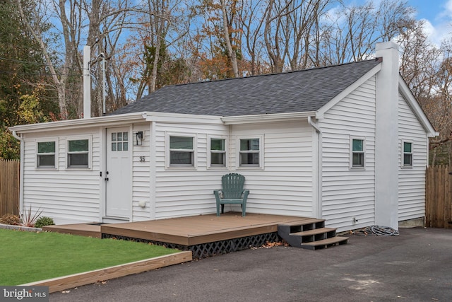 rear view of property featuring a wooden deck