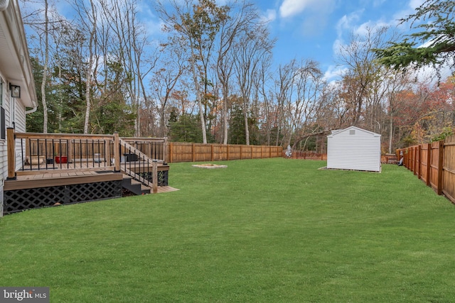 view of yard featuring a shed and a deck