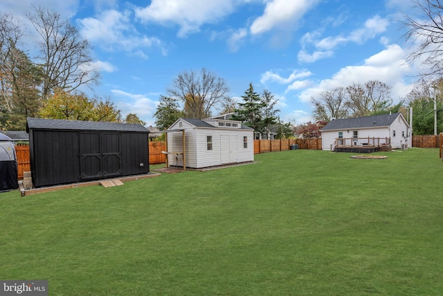 view of yard featuring a storage shed and a wooden deck