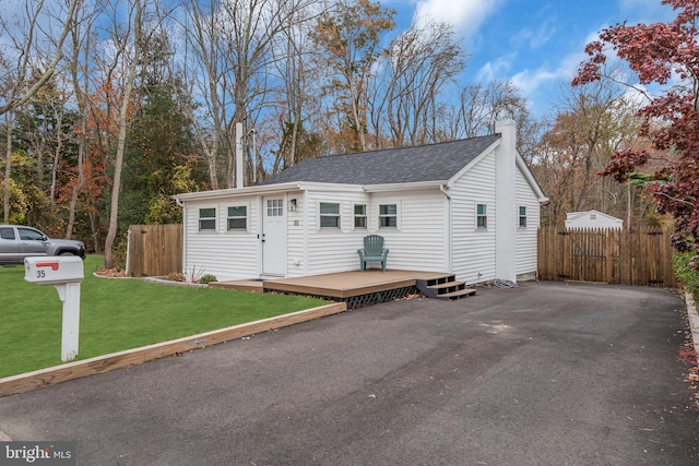 exterior space with a deck and a front yard