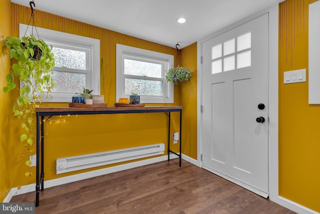 foyer entrance featuring dark wood-type flooring and a baseboard heating unit